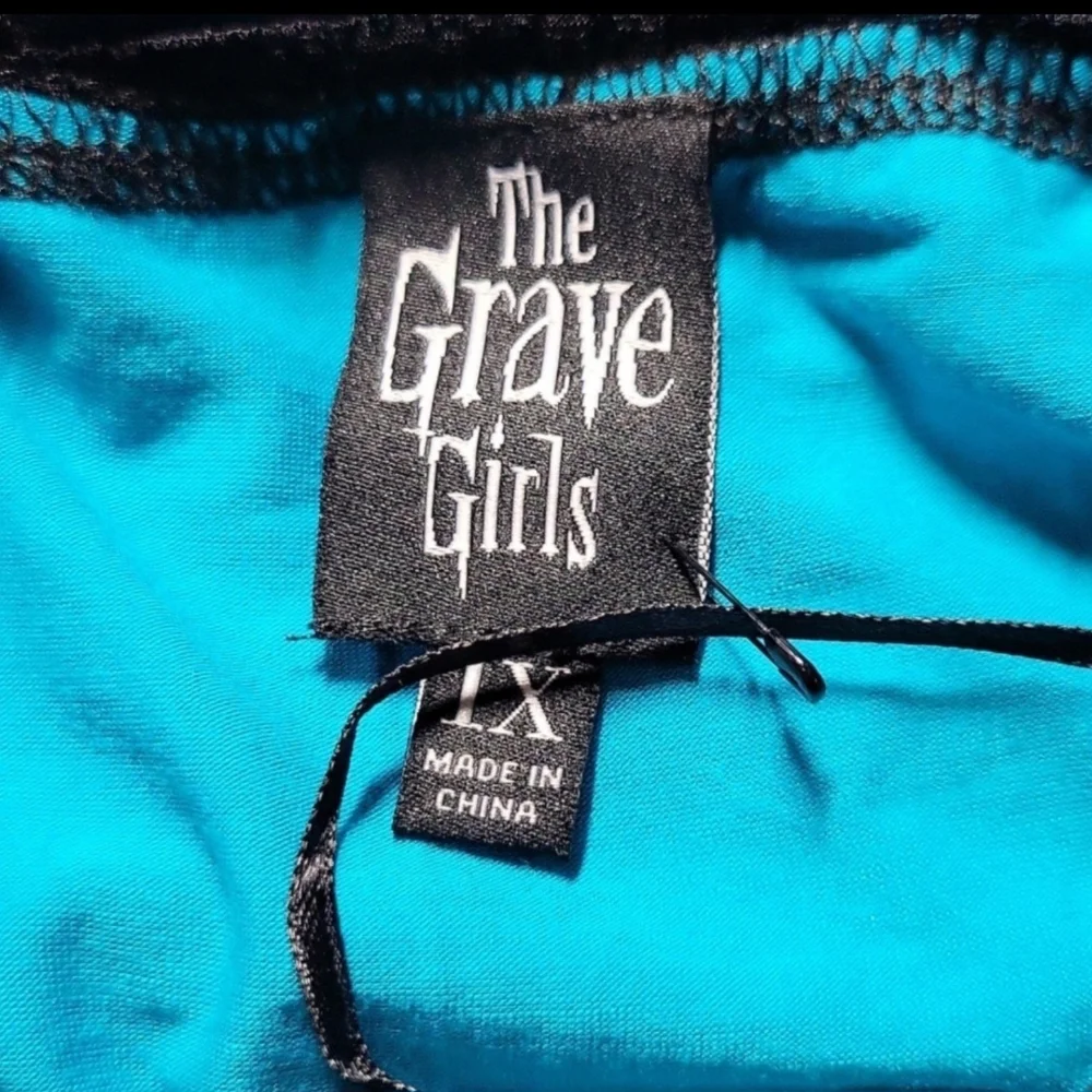 Chic Asymmetrical Teal Dress with Black Trim - Picture 8 of 9